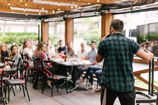 man talking in front of a group of people