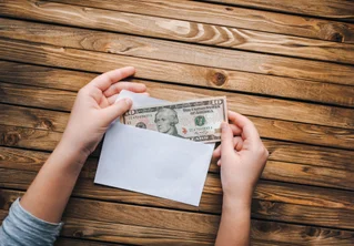 Money going in envelope